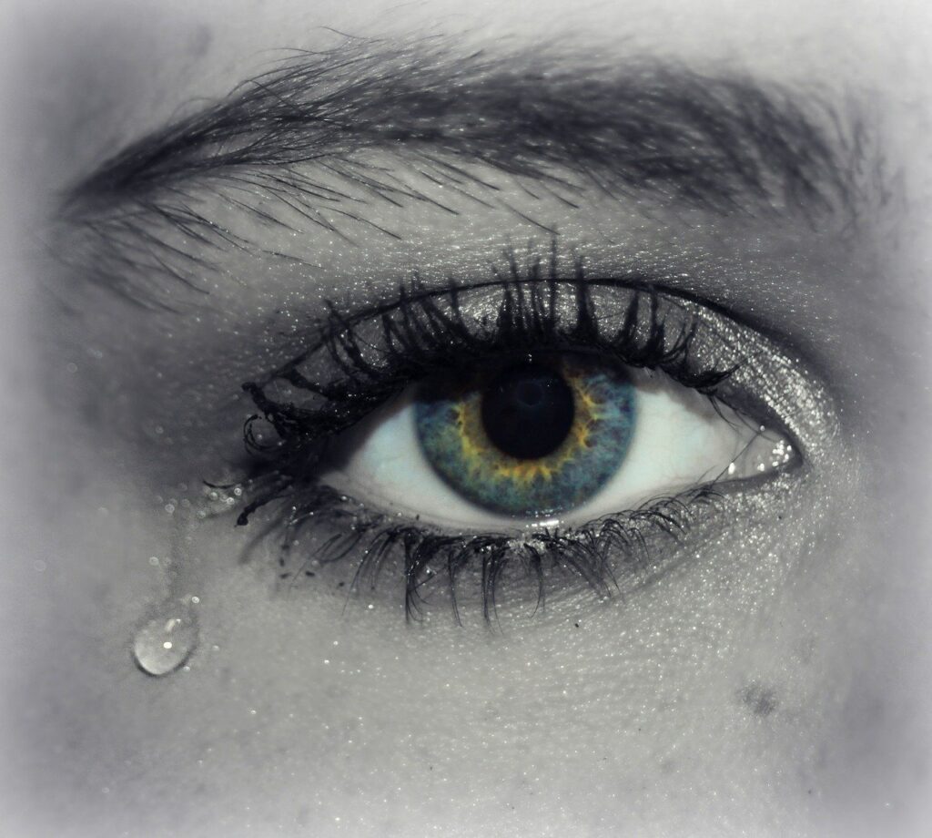 Image is a close-up of one eye with a tear rolling down the woman's cheek.
Image by Cheryl Holt from Pixabay 