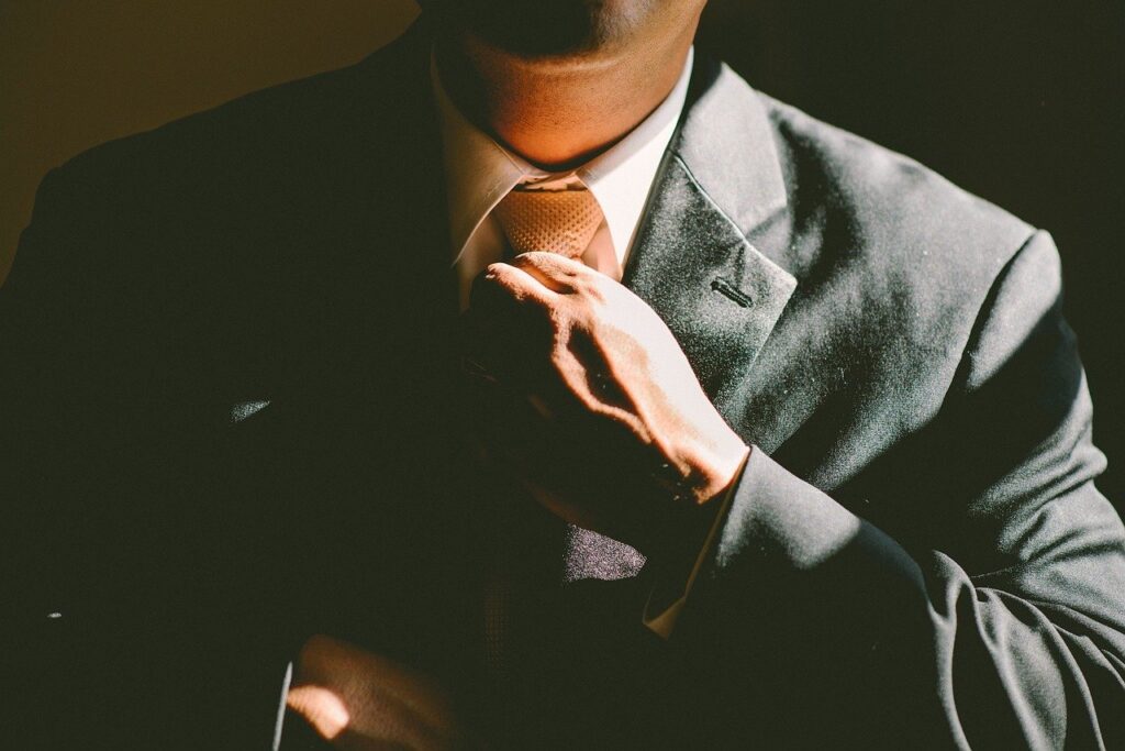 Man in a suit adjusting his tie.
Image by Free-Photos from Pixabay 