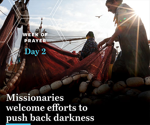 Photo of fisherman taking up a net on a boat, in the sunshine. The words on the image are "Week of Prayer - Day 2" and "Missionaries welcome efforts to push back darkness" Photo is from imb.org for Week of Prayer for International Missions