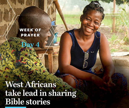 Two people, a man and a woman sitting outside a house in West Africa, smiling, talking. Believers in West Africa have a heartfelt passion to share the gospel through storytelling, also know as the orality method. A week of prayer for International Missions, day 4. Photo provided by IMB.