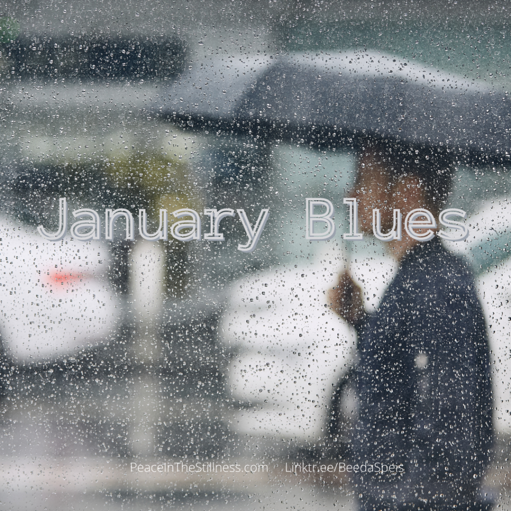 A person with an umbrella standing in the rain and the words "January Blues" on it. by Beeda Speis for Peace in the Stillness blog.