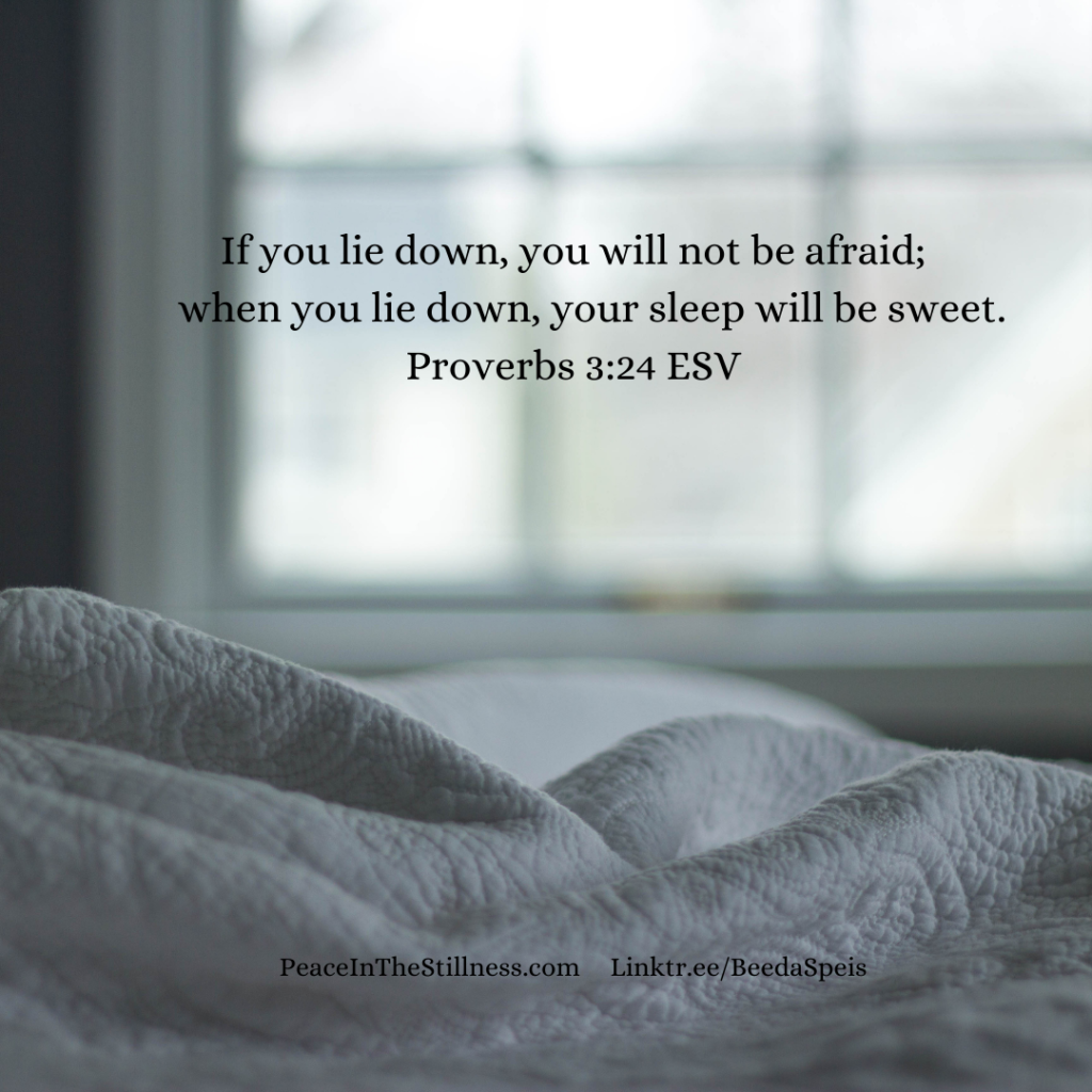 A phone of a white quilt in the foreground and a blurred window in the background. The words to Proverbs 3:24 ESV, "If you lie down, you will not be afraid;  when you lie down, your sleep will be sweet.